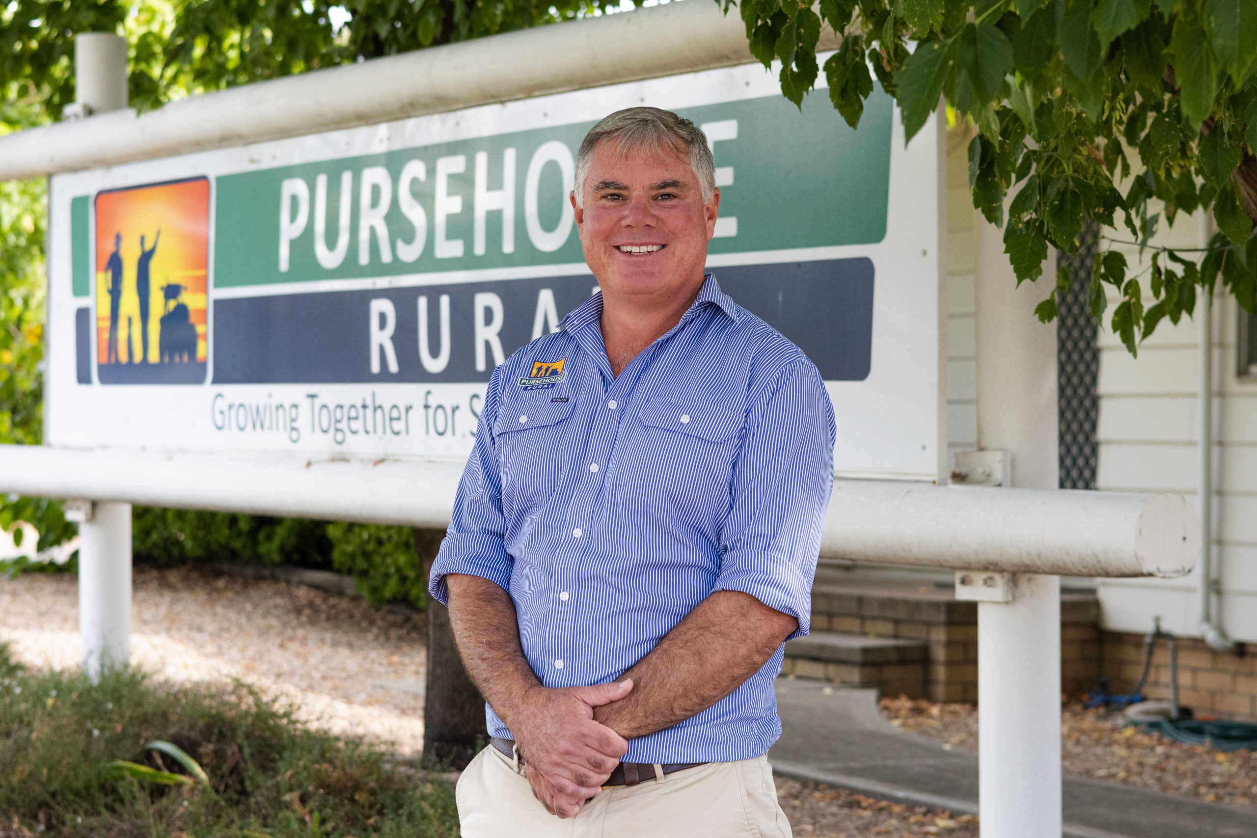 Pursehouse Rural CEO, Scott Pursehouse, stands in front of large Pursehouse Rural sign